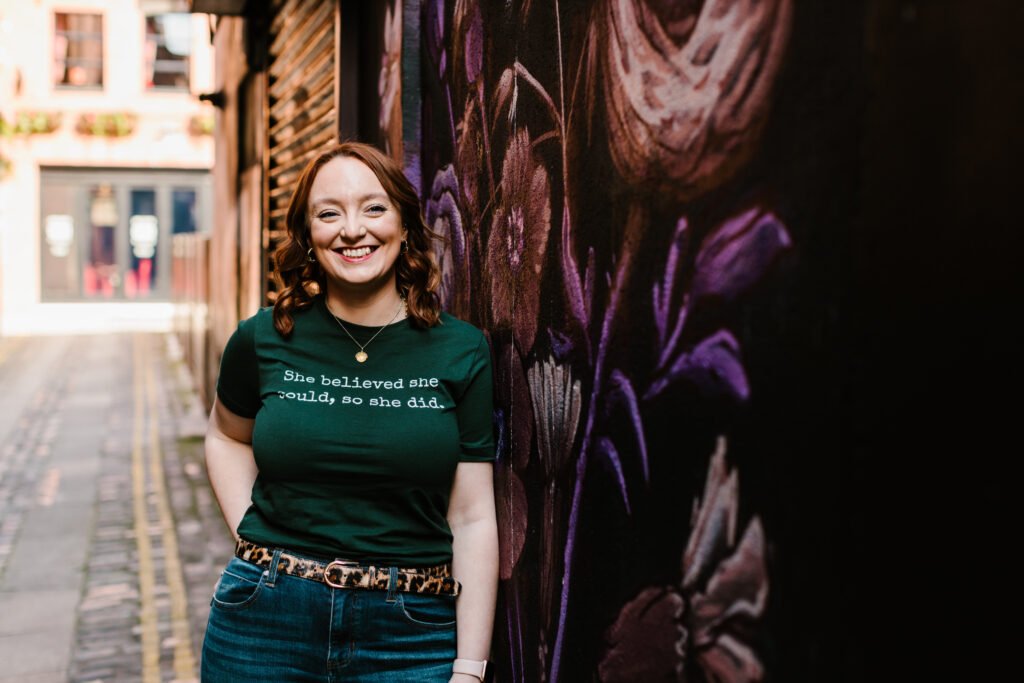 Joy Dreaning Leaning Against Wall Helping Millennial Women Find Your Wild